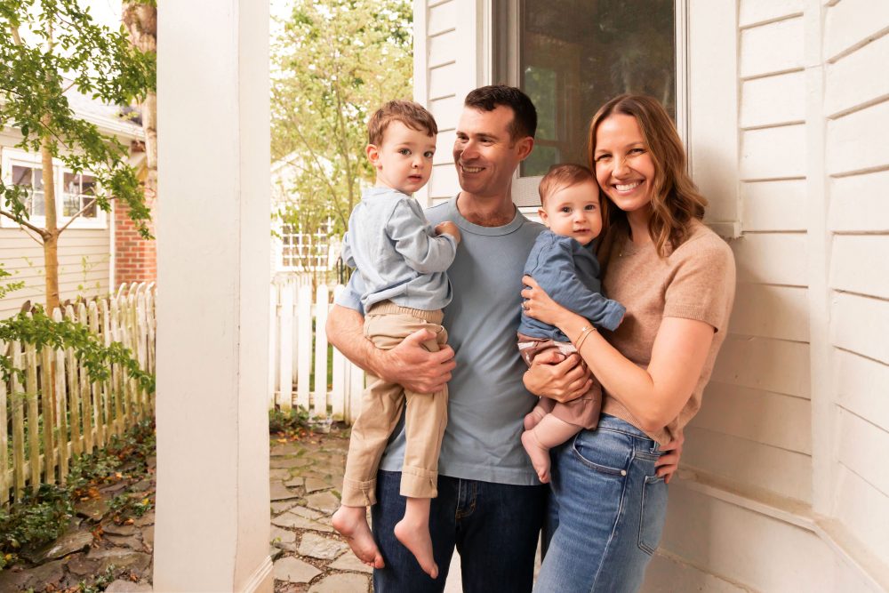Natural family portraits featuring a father playing with his toddler and a mother cuddling their baby.